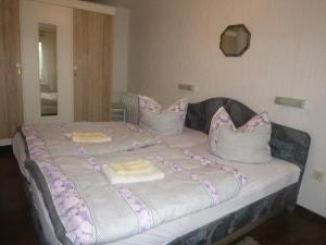 a large bed with pillows on top of it at Ferienhaus Görsdorf Berlin in Berlin