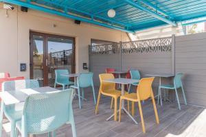 a group of tables and chairs on a patio at KYRIAD DIRECT TOULON OUEST - La Seyne sur Mer in La Seyne-sur-Mer