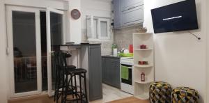 a kitchen with white cabinets and a counter top at Teo Apartment in Trebinje