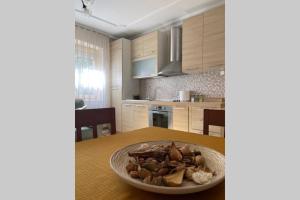 a kitchen with a bowl of food on a table at Cozy apartment in the Old Center of Prishtina in Pristina