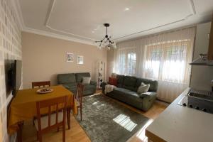 a living room with a couch and a table at Cozy apartment in the center of Prishtina in Pristina