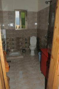ein Badezimmer mit einem WC, einer Badewanne und einem Waschbecken in der Unterkunft Fridays Hotel in Shongran