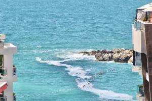 a view of the ocean from between two buildings at 1bd Sea View Apts Veliki Pjesak "Mula" in Dobra Voda