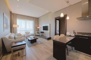 a large living room with a kitchen and a living room at The House Boutique Suites in Amman