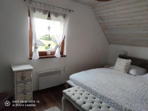 a bedroom with a bed and a window at MJ Vila in Stará Lesná