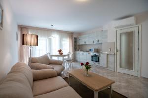 a living room with two couches and a table at Antik Apartments in Balchik
