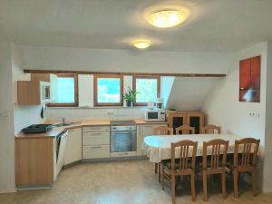 a kitchen with a table and chairs in a room at Apartments Sušnik in Bohinj