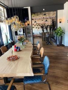 długi stół w pokoju z krzesłami i tableasteryasteryasteryasteryastery w obiekcie Boutique Hotel de Valk w mieście Valkenswaard