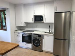 A kitchen or kitchenette at Apartamentos El Puente