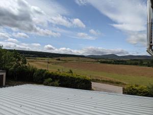 
a field with a view of a mountain range at Edderton Lodge in Tain
