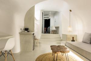 a living room with a couch and some stools at Anila Suites in Fira