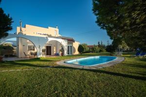 a house with a swimming pool in the yard at Villa Kalotina in Kremasti