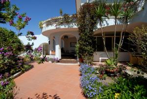 a house with flowers and plants in front of it at Hotel Terme Villa Teresa in Ischia