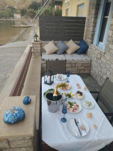 a picnic table with plates of food on it at Symi . VILLA CALME (Sur la Mer). in Symi