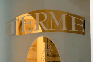 a sign that saysarma on a wall over a window at Hotel Terme Villa Teresa in Ischia