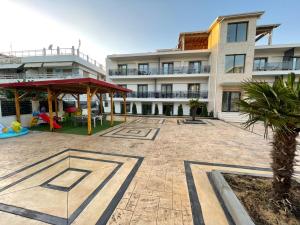 a large building with a playground in front of it at Grand Agia Triada in Agia Triada