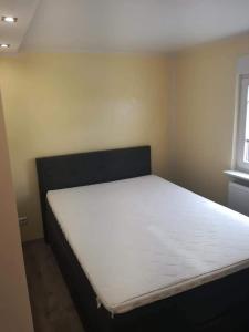 a bedroom with a large white bed in a room at Ferienwohnung Klockenhagen 2 in Ribnitz-Damgarten