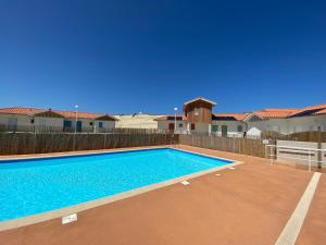 a swimming pool in the backyard of a house at Residence Plage Oceane in Biscarrosse-Plage