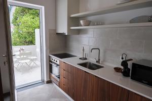 a kitchen with a sink and a counter top at Casas do Mercado - Casa Sirius in Angra do Heroísmo