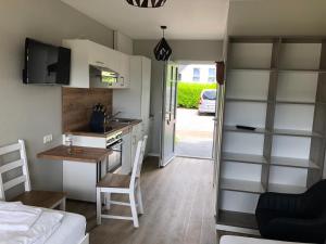 a small kitchen with a desk and a kitchen with a bed at Bauernhof Köhlbrandt in Todendorf auf Fehmarn