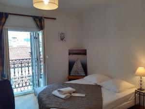 a bedroom with a bed with two towels on it at Stella Apartment - Cannes in Cannes