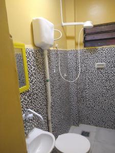 a bathroom with a shower with a toilet and a sink at Hotel 678 in Boa Vista