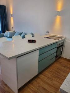 a kitchen with a white counter top and a couch at Charming Bellagio SUN CLUB in San Bartolomé