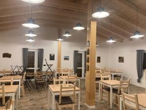 a room with wooden tables and chairs and lights at Azienda Agricola Saint Hubert in Cantalupo Ligure