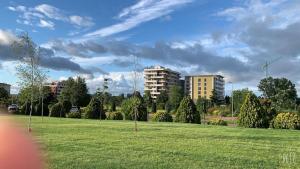 a park with a field of grass and buildings at Aparthotel Black Sea in Constanţa