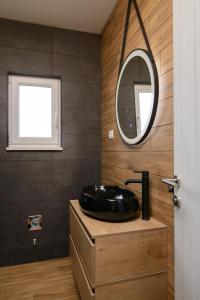 a bathroom with a black sink and a mirror at Apartments Pelja in Trogir +39 photos