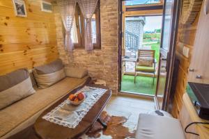 a living room with a couch and a table at Lux Bungalow in Žabljak