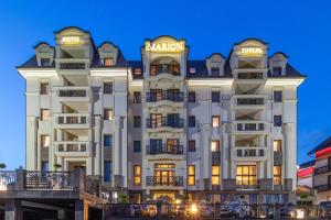 a rendering of the mgm hotel at night at MARION SPA Hotel & Spa - RENOVATION - Rooms, SPA area, Swimming pool, Reception, Restaurant, Lounge Bar, Hookah bar, Children's room, Parking, SPA and Breakfast included in the price in Bukovel +37 photos