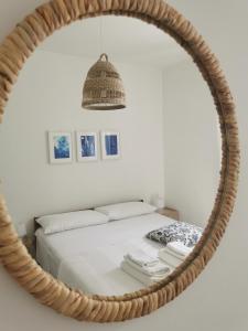 a bedroom with a bed in a round mirror at Domus Taura in Terracina