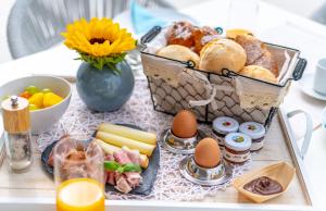 a tray with eggs and other foods on a table at Pareus Beach Resort in Caorle
