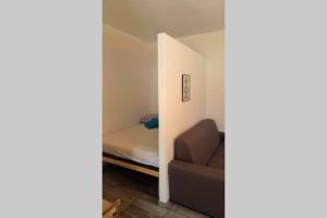 a small room with a bed and a chair at Kati 1 in Sveti Filip i Jakov +1 photo