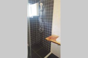 a bathroom with a shower with blue tiled walls at Kati 1 in Sveti Filip i Jakov