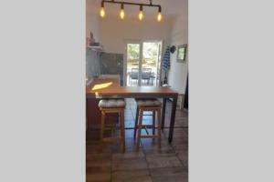 a kitchen with a wooden table and stools at Kati 1 in Sveti Filip i Jakov