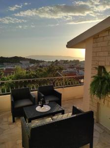 a patio with two chairs and a table on a balcony at Apartment Sky Central in Makarska