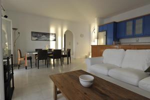 a living room with a white couch and a table at Armenistis Apartment in Naousa