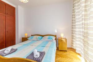 Postel nebo postele na pokoji v ubytování Apartments Slavko + 24 fotografií