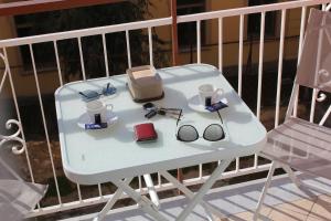 a white table with glasses and a cooler on a balcony at B&B 80056 Ercolano in Ercolano