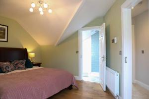 a bedroom with a bed and an open door at 5* Self Catering in Nenagh