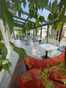 a patio with tables and chairs in a building at Moris Boutique Beach Hotel in Gdańsk