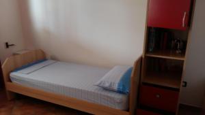 a small bedroom with a bed and a book shelf at Vacanze Porto Cesareo Salento in Torre Lapillo