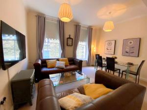 a living room with a couch and a table at Fabulous 2 bed Ground floor apartment Belper in Belper