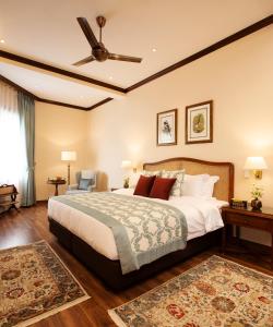 a bedroom with a large bed and a ceiling fan at Daleside Manor, Boutique Hotel, Kasauli in Kasauli
