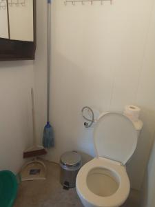 a small bathroom with a toilet and a trash can at каравана Марбея in Chernomorets