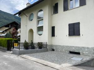 een wit huis met zwarte ramen in een straat bij Casa Dolce Casa in Tirano