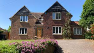 a brick house with flowers in front of it at Hillview in Saint Margaretʼs at Cliffe