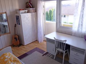 a desk and a chair in a room with a window at Risør Bed & Breakfast, Randvik Strand in Risør